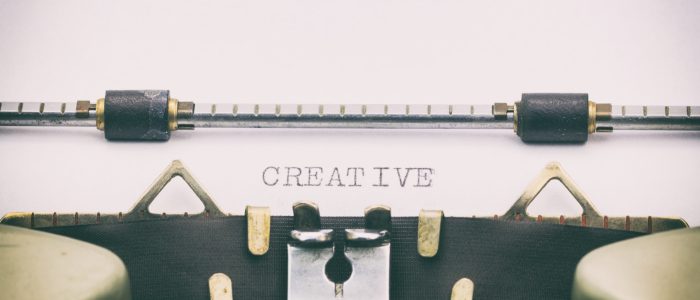 Close-up of word Creative on a typewriter sheet